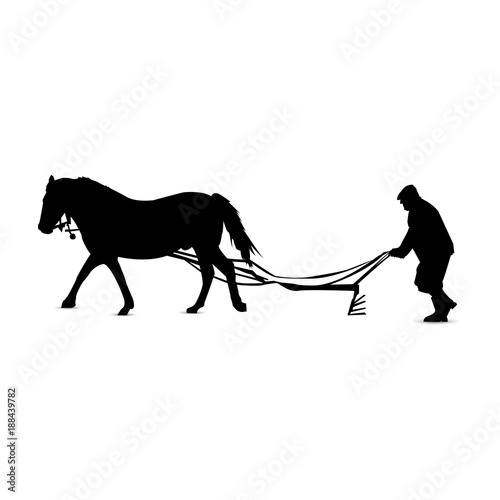 Silhouette of country man plowing by horse.