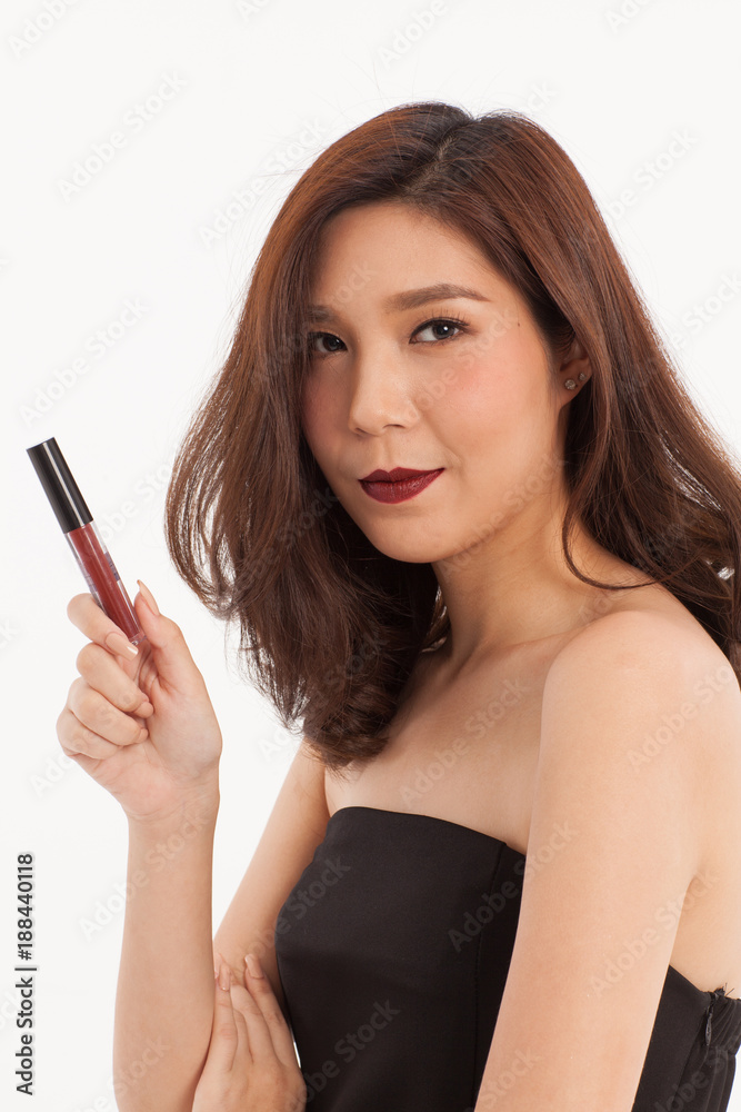 An attractive Asian girl with cosmetic lipstick smiling on white background. An attractive Asian girl with cosmetic lipstick smiling on white background.