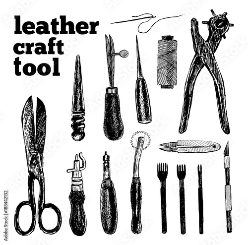 Leather craft tools and utensils on a white wooden background
