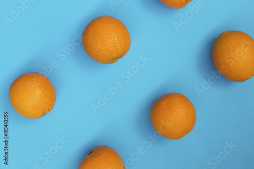 Top view of colorful fruit pattern of fresh orange on blue background