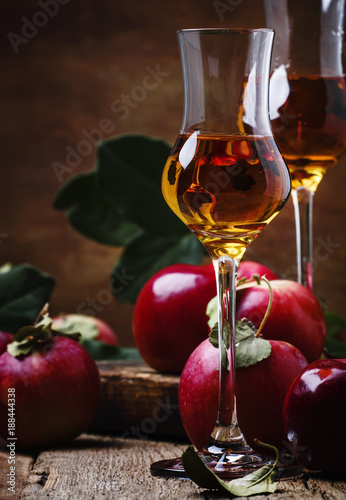 French apple strong alcoholic drink, still life in rustic style, vintage wooden background, selective focus