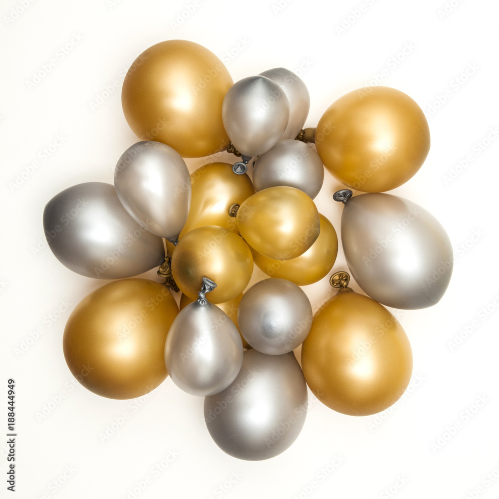 Gold and silver party celebration balloons on a plain background Gold and silver party celebration balloons on a plain background