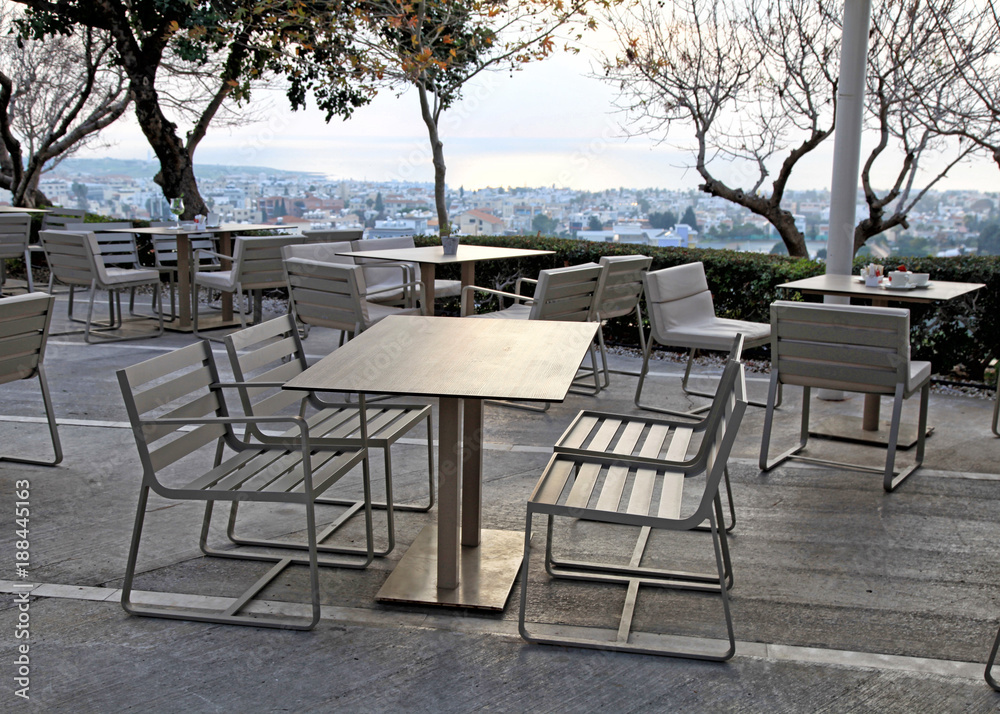 tables and chairs in outdoor cafe on sunset