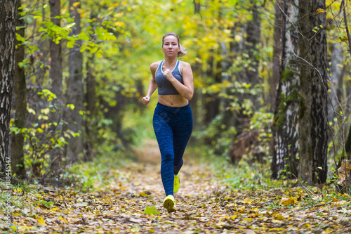 Woman running in the autumn park