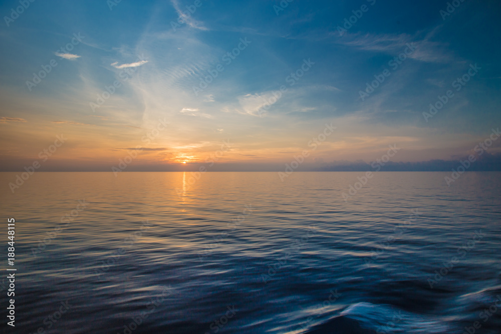 Sunset at the horizon at sea