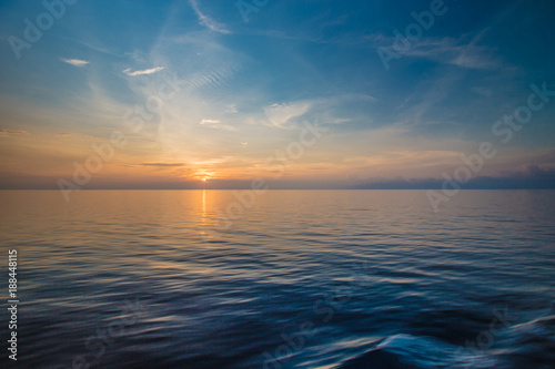 Sunset at the horizon at sea © behrinmind