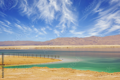 Wallpaper Mural Turquoise water of the Dead Sea, Israel. Between the sea and dry mountains of red sandstone highway passes.  Torontodigital.ca