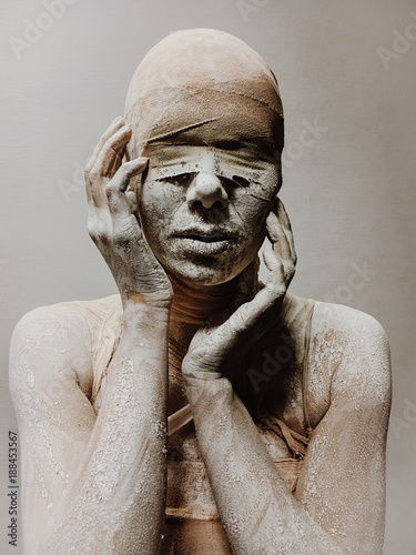 Fototapet in makeup woman in bandages and clay is like a mummy without eyes on a monophoni