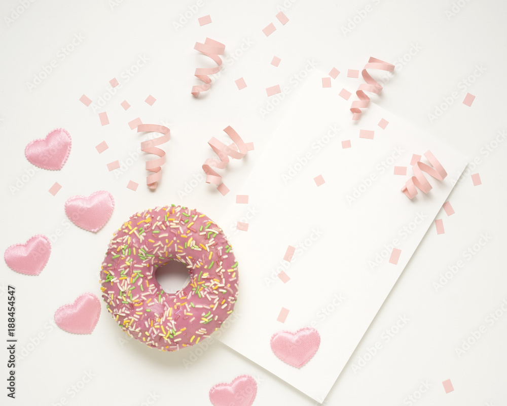 Valentine card / Creative valentine concept photo of donut with hearts and card on white background.