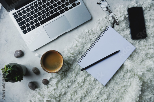 laptop computer, coffee mug, notebook and smart phone on white background