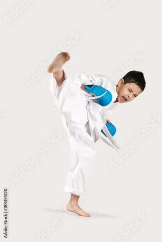 boy of the karateka in a white kimono battles or trains