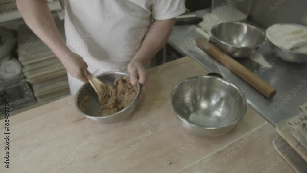 Slow motion, baker mixes bowl of cinnamon sugar Slow motion, baker mixes bowl of cinnamon sugar