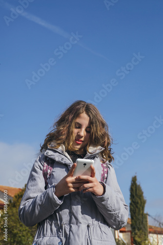 teenage girl student with smartphone