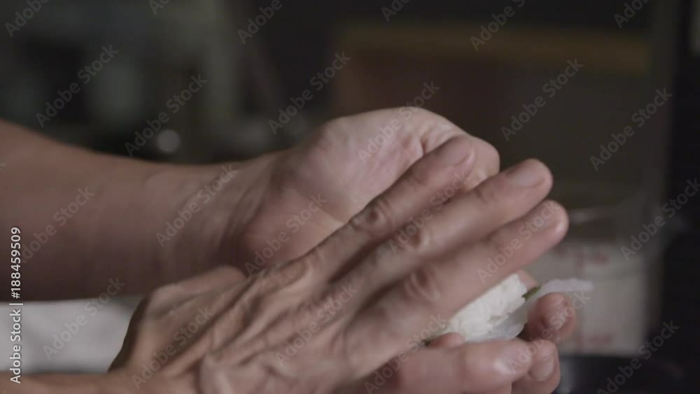 Chef rolls rice for sushi, slow motion Chef rolls rice for sushi, slow motion