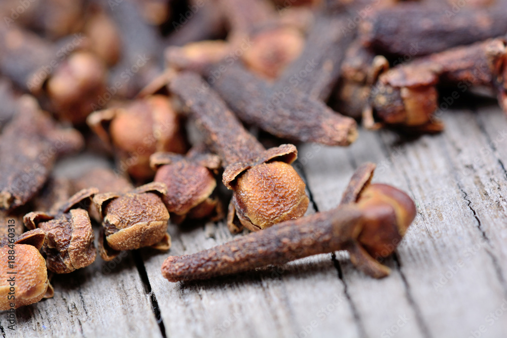 Heap of cloves on rustic wooden table Heap of cloves on rustic wooden table