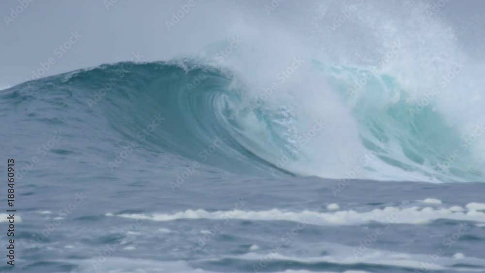 SLOW MOTION, CLOSE UP: Small tube wave reaching rugged black beach on a refreshing morning. Rocky black beach struck by barrel wave on a misty day. Foggy morning at the beach with splashing ocean wave SLOW MOTION, CLOSE UP: Small tube wave reaching rugged black beach on a refreshing morning. Rocky black beach struck by barrel wave on a misty day. Foggy morning at the beach with splashing ocean wave