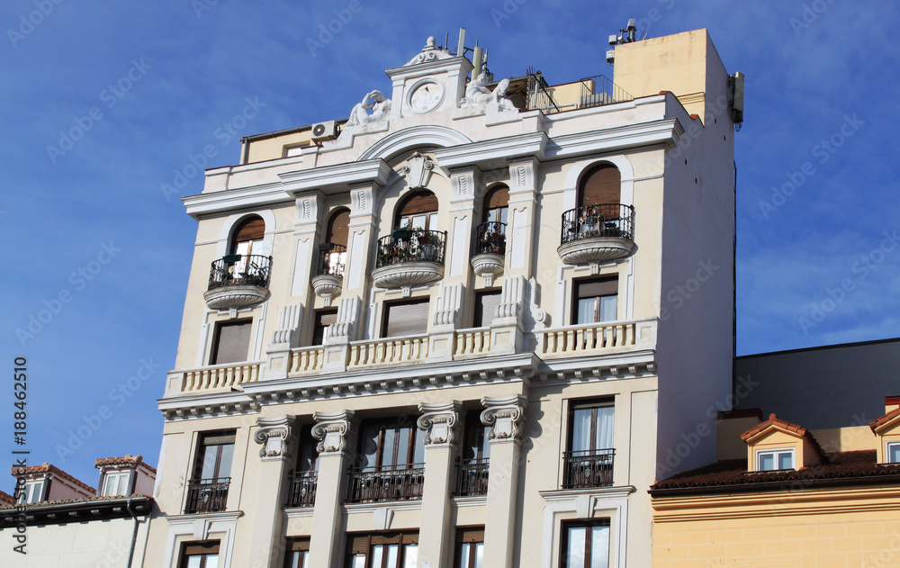 Facade of a white historical building in the old town of Madrid, Spain