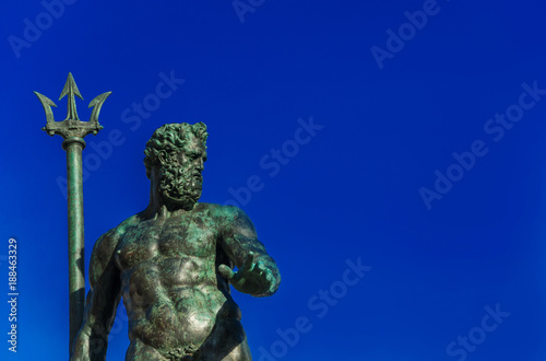 Neptune God of the Sea bronze statue with trident  from the Fountain of Neptune  erected in 1566 in the historic center of Bologna  with copy space 