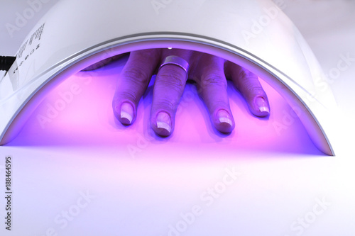Bilde på lerret Manicure with uv led lamp, curing gel or hybrid varnish, manicure on table