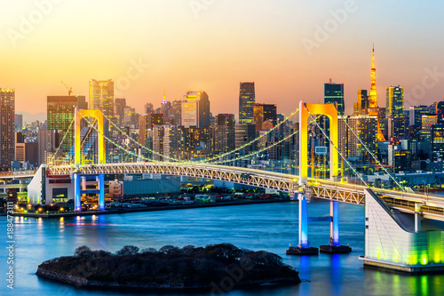 Asia Business concept for real estate and corporate construction - panoramic modern city skyline bird eye aerial view of Odaiba, tokyo tower & rainbow bridge under golden sun in Tokyo, Japan © voyata