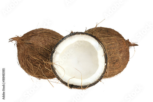 Natural coconut. Two whole coconuts and one in a cut on a white background. 
