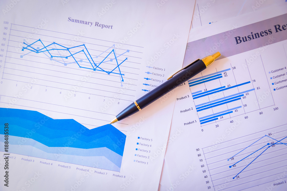 Many charts and graphs with magnifying glass and many pencil. Reflection light and flare. Concept image of data gathering and statistical working. Many charts and graphs with magnifying glass and many pencil. Reflection light and flare. Concept image of data gathering and statistical working.