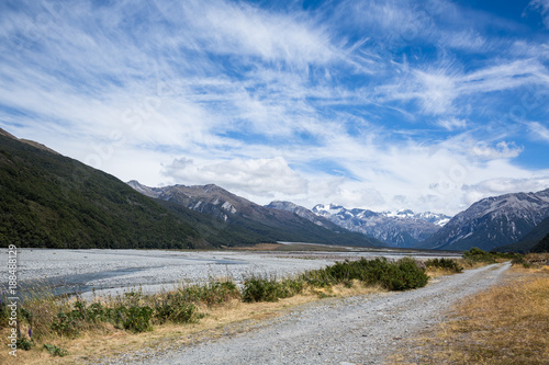 Gravel road along braided river of New Zealand's Southern Alps