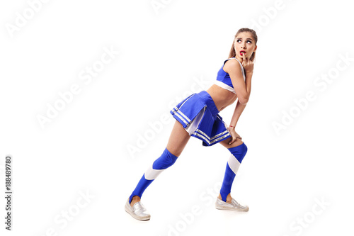 Young cheerleader in blue and white suit on white background. Isolated on white background.