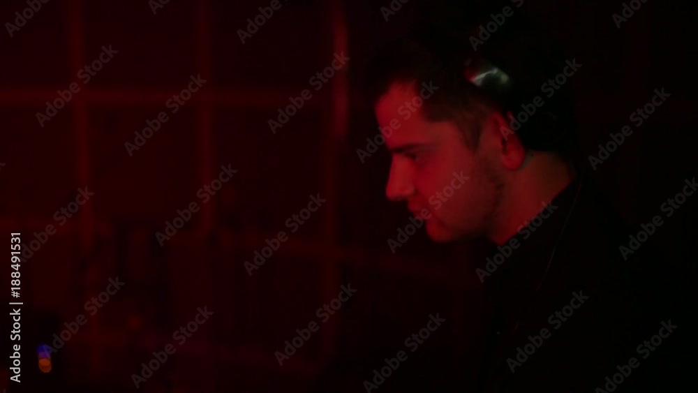 A professional DJ plays musical compositions for people dancing in the club. Musical equipment. Moution camera A professional DJ plays musical compositions for people dancing in the club. Musical equipment. Moution camera