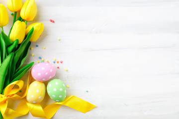 Happy Easter. Congratulatory easter background. Easter eggs and flowers.