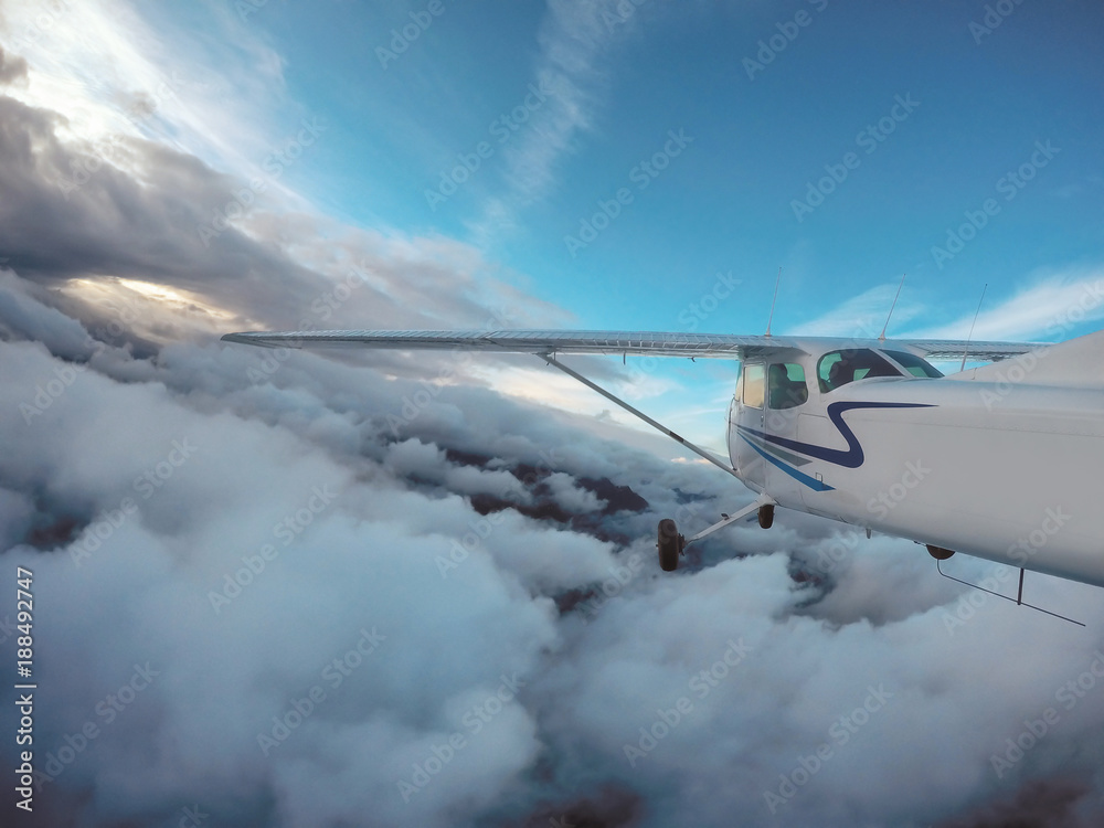 Fototapeta premium Small single engine airplane is flying over Canadian Landscape near Vancouver, British Columbia, Canada.