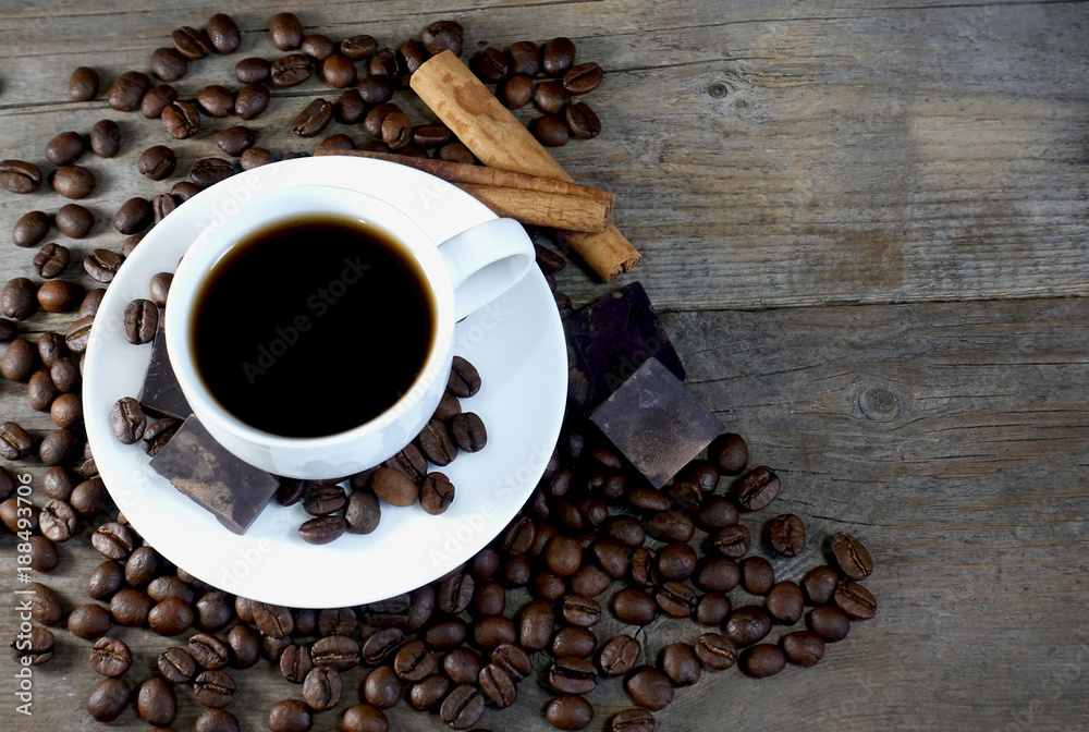 Top view of a cup of coffee with bunch of coffee beans and space for text on a wooden background. Top view of a cup of coffee with bunch of coffee beans and space for text on a wooden background.
