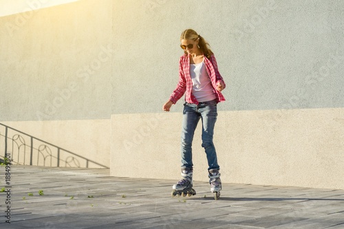 Active sports teen in roller skates on the urban background