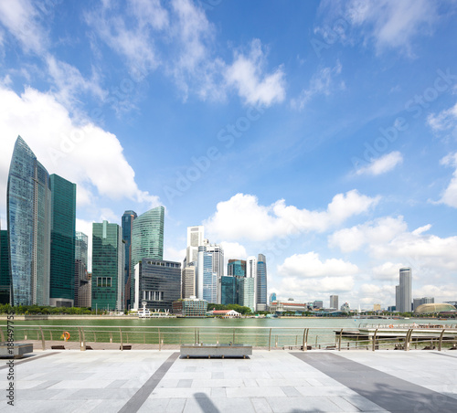 empty marble floor with modern buildings near water