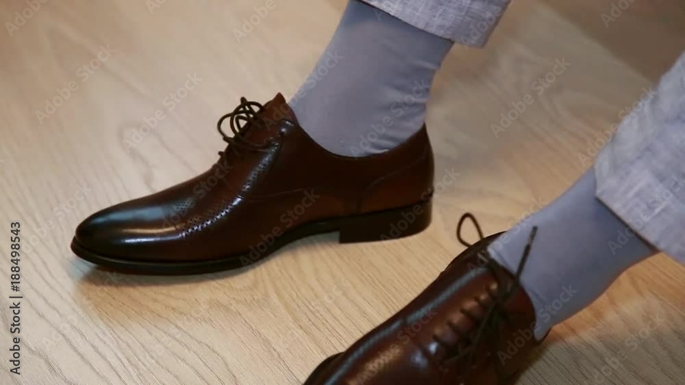 Wedding, close-up bridegroom wears stylish brown shoes Wedding, close-up bridegroom wears stylish brown shoes