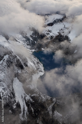 Striking Aerial Landscape of a glacier Lake surrounded by rugged mountain landscape. Located East of Seattle and Vancouver, in Washington State. 
