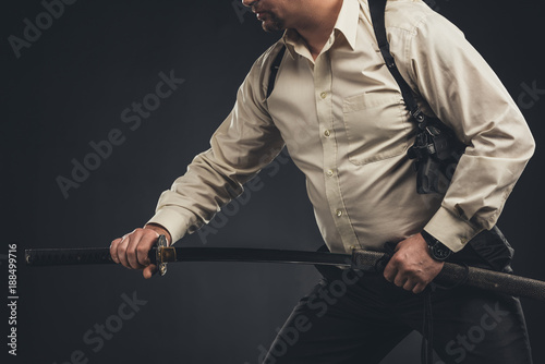 cropped shot of yakuza member taking out his katana sword