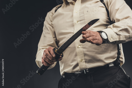 cropped shot of yakuza member with japanese tanto knife