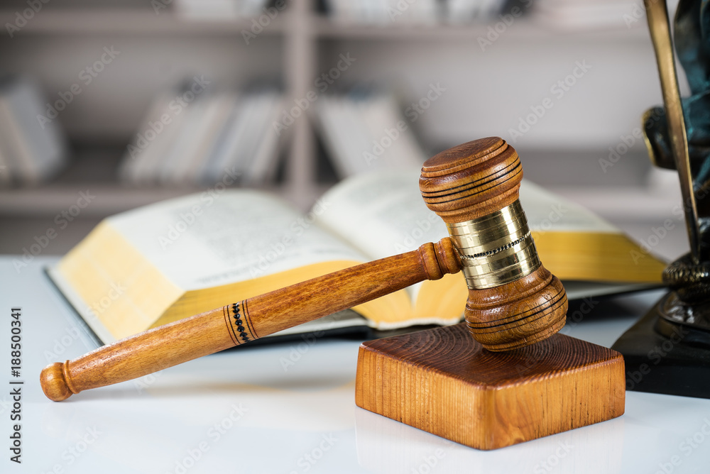 Law and Justice concept. Mallet of the judge, books, scales of justice. Gray stone background, reflections on the floor, place for typography. Courtroom theme. Law and Justice concept. Mallet of the judge, books, scales of justice. Gray stone background, reflections on the floor, place for typography. Courtroom theme.