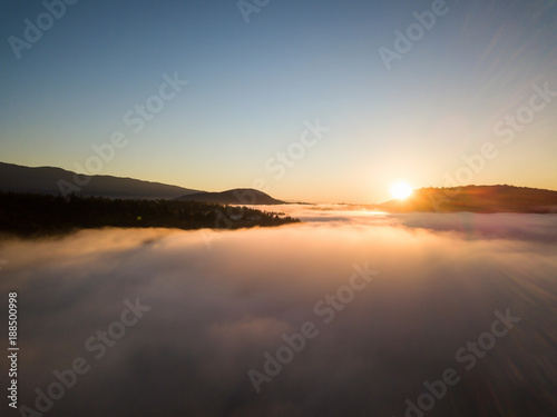 Aerial view of the fog covering North Vancouver  British Columbia  Canada  during a vibrant sunrise