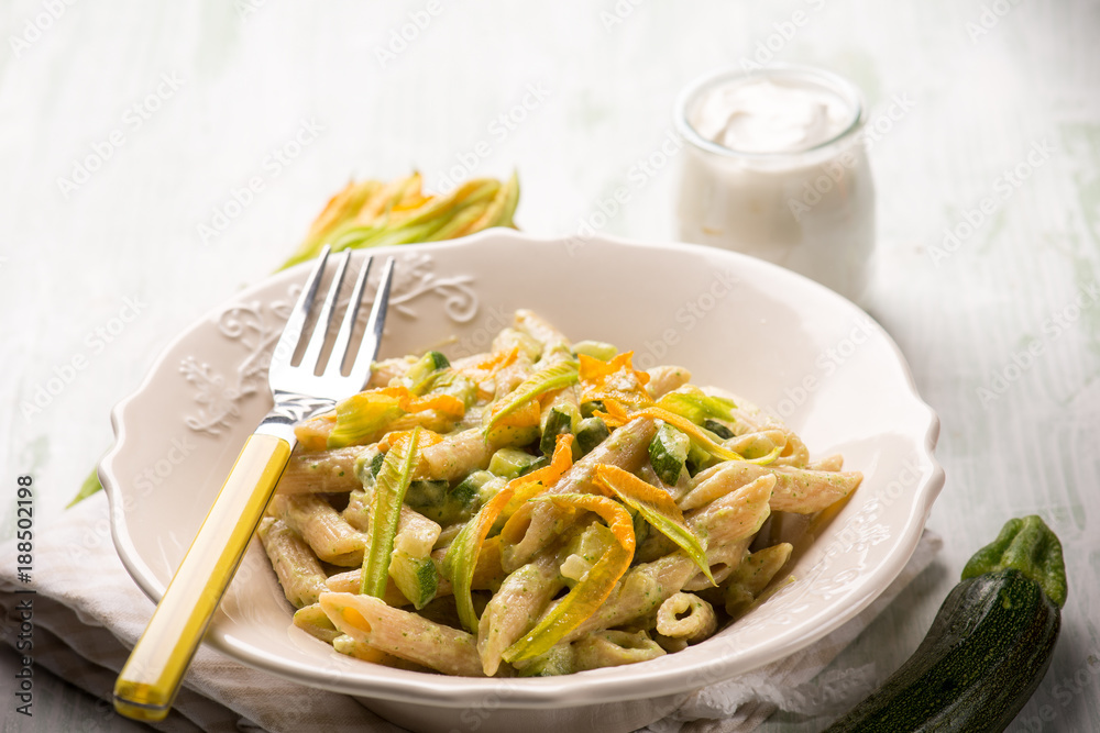 pasta with zucchinis flowers and cream sauce or yogurt, selective background pasta with zucchinis flowers and cream sauce or yogurt, selective background