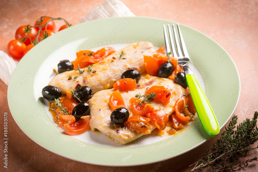 escalope with tomatoes olives and thymus, selective focus escalope with tomatoes olives and thymus, selective focus