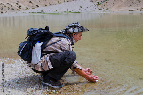 Photo of a tired traveler, washing itself from the sacred Dhankar lake