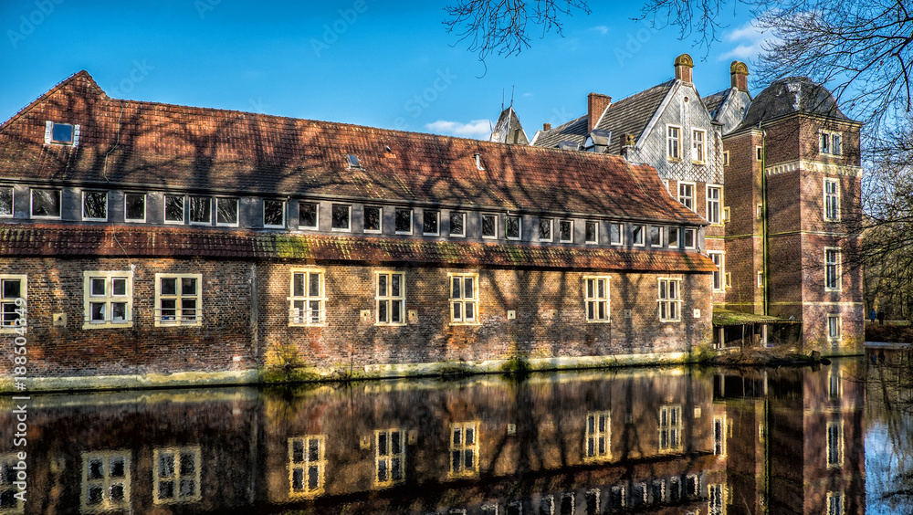 Fototapeta premium Senden, Coesfeld, Musterland December 2017 - Watercastle Wasserschloss Schloss Senden during sunny day in Winter