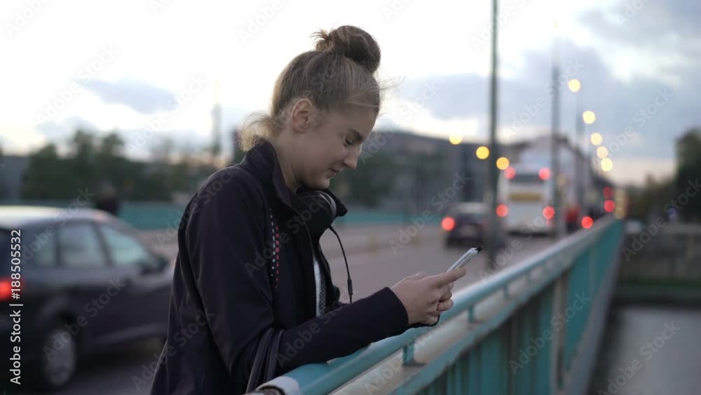 Young teenager girl surfing Internet on smartphone stand on the bridge in the city
Young teenager girl surfing Internet on smartphone stand on the bridge in the city