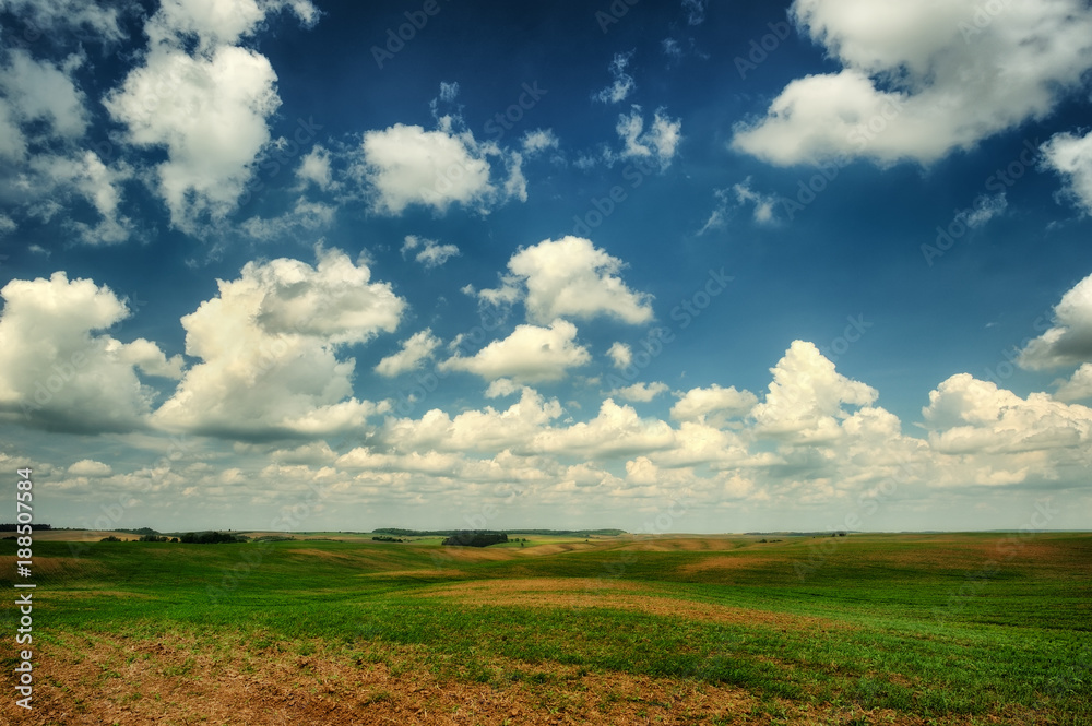 hilly field. a picturesque sky over a hilly field hilly field. a picturesque sky over a hilly field