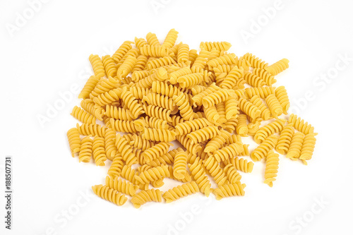 uncooked fusilli pasta noodles isolated on white background