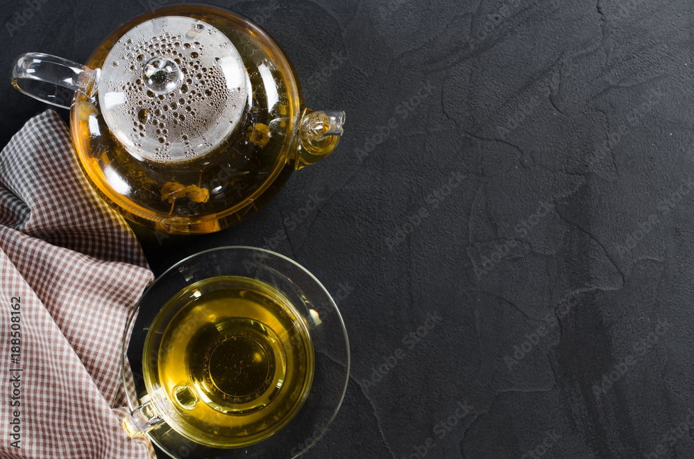 Cup of delicious herbal tea and glass teapot. Cup of delicious herbal tea and glass teapot.