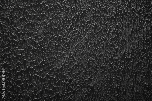 plaster stucco black wall background, grunge rough ragged texture