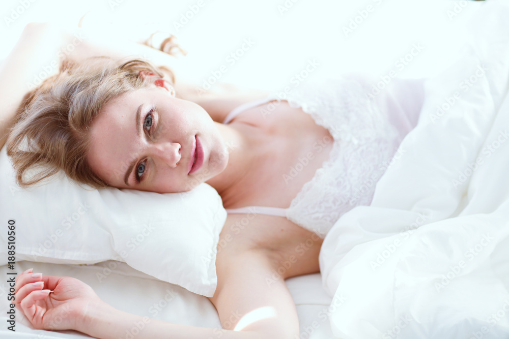 Pretty woman lying down on her bed at home. Pretty woman lying down on her bed at home.